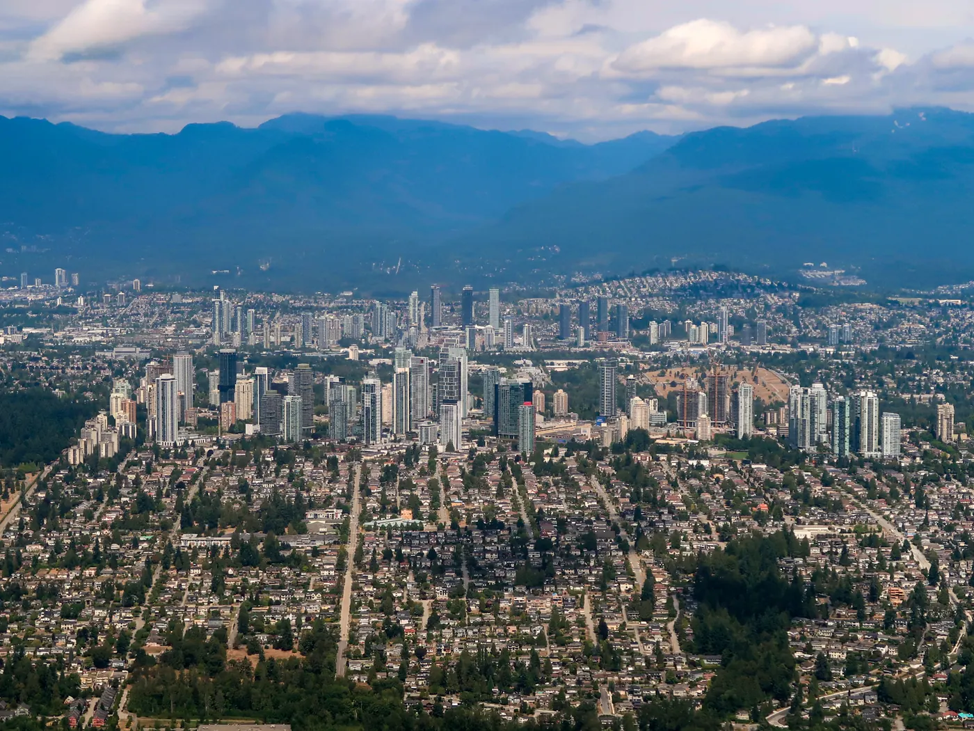 Aerial view of Burnaby with the Metrotown towers and North Shore mountains