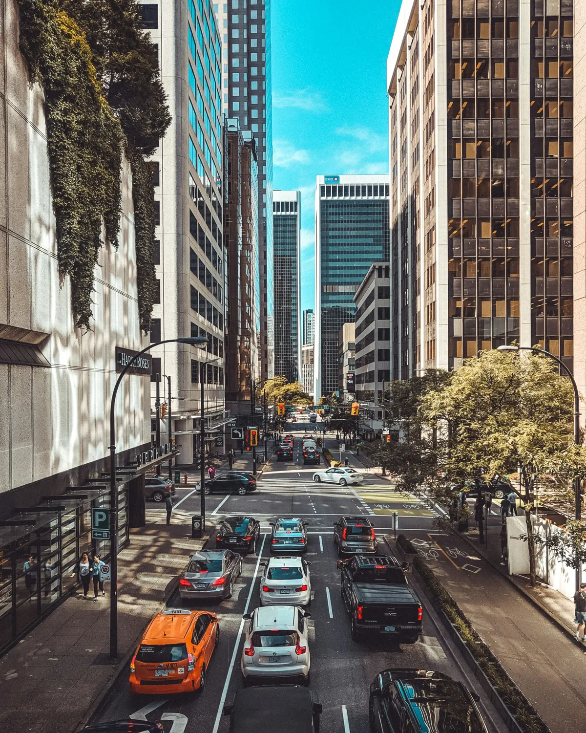 A downtown Vancouver street lined with towers and traffic