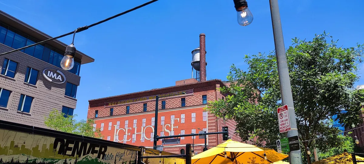 A brick industrial building under a blue sky