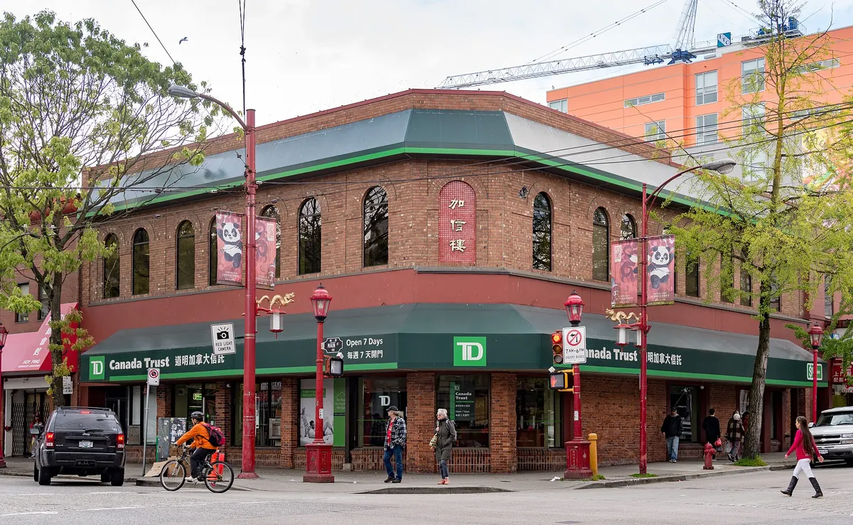A corner building with street-level shops in Vancouver