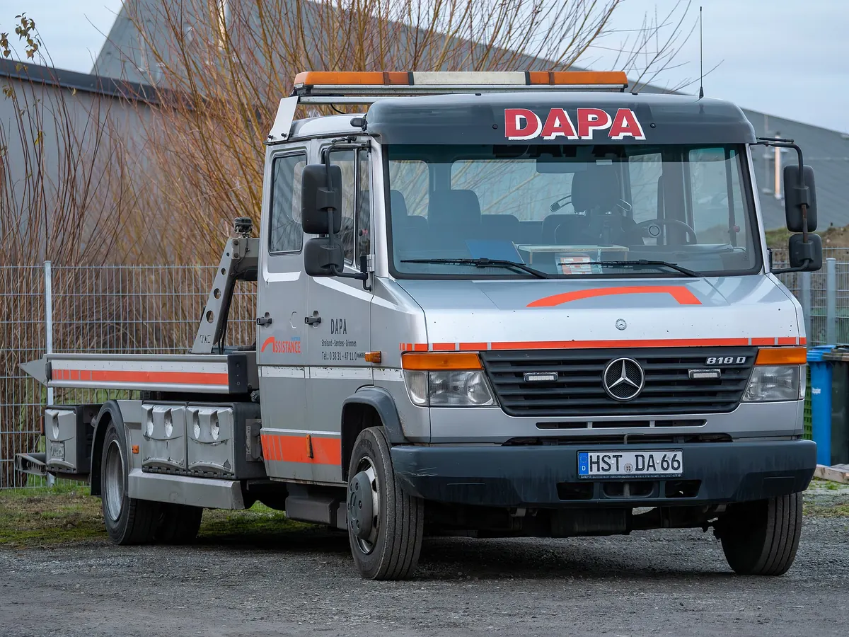 A flatbed tow truck parked on a city street