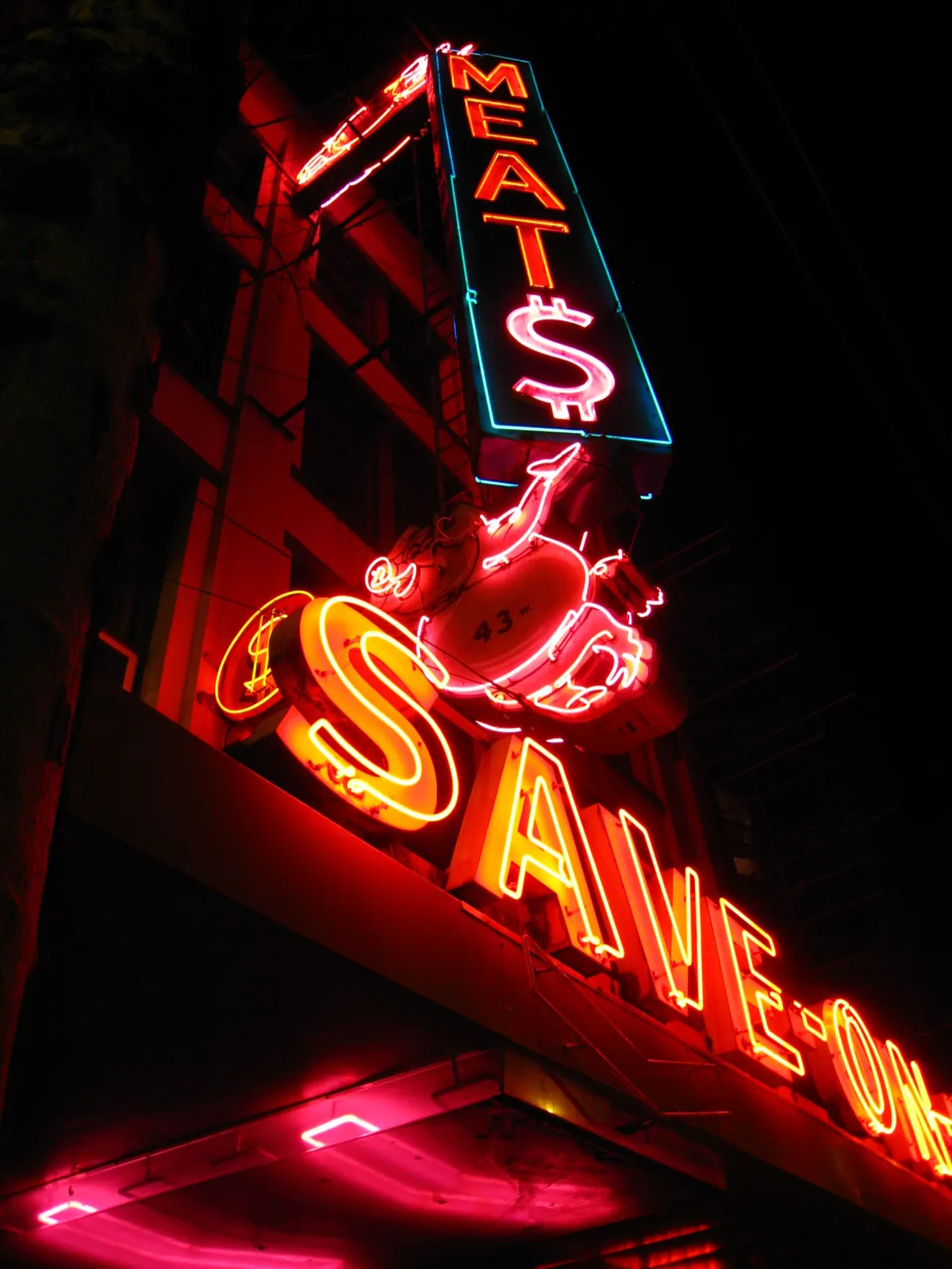 A neon sign lit up at night on Hastings Street in Vancouver